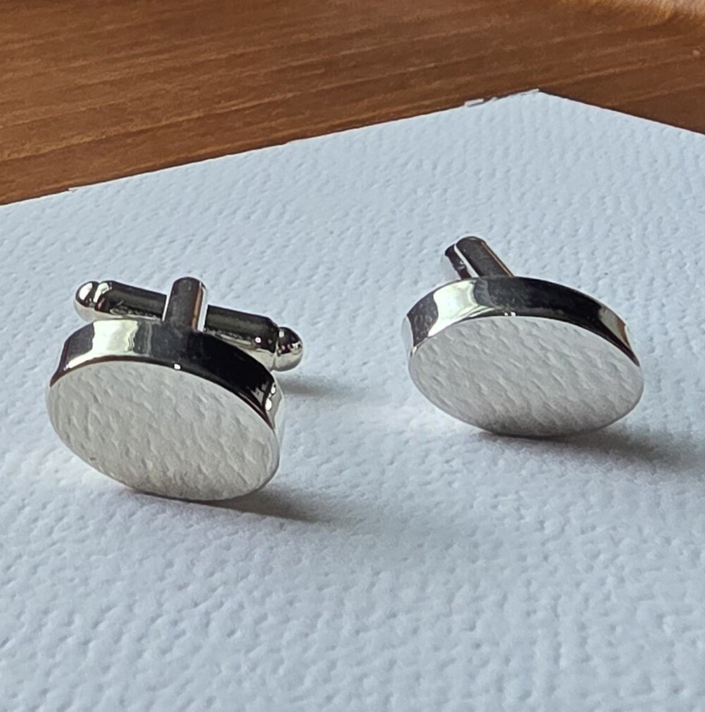 Classic silver-tone metal cufflinks featuring a polished oval face